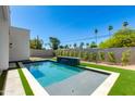 Backyard pool with fountain feature, turf, and a concrete patio surround at 2927 E Osborn Rd, Phoenix, AZ 85016