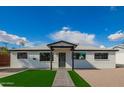 Charming single-story home with well-maintained lawn and inviting front porch at 3044 W Dahlia Dr, Phoenix, AZ 85029