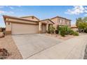 Inviting single-Gathering home with a two-car garage, desert landscaping, and a well-kept front yard at 318 E Taylor Trl, San Tan Valley, AZ 85143