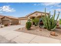 Welcoming one-story home with desert landscaping, a two-car garage, and a clean, paved driveway at 318 E Taylor Trl, San Tan Valley, AZ 85143