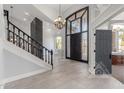 Grand foyer features a stunning staircase, soaring ceilings, and an elegant chandelier at 3413 E Equestrian Trl, Phoenix, AZ 85044