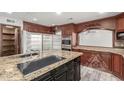 Modern kitchen featuring granite countertops, stainless steel appliances, and custom wood cabinetry at 3413 E Equestrian Trl, Phoenix, AZ 85044