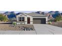 Charming single story home showcasing desert landscaping and a two car garage at 35545 N Breezy Ln, San Tan Valley, AZ 85140