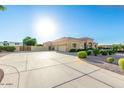 Spacious home with a large driveway and well-maintained landscaping, ideal for comfortable and convenient living at 35662 N Creekside Ln, Queen Creek, AZ 85144