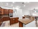 Spacious kitchen featuring granite countertops, ample cabinet space, and modern appliances, perfect for cooking at 35662 N Creekside Ln, Queen Creek, AZ 85144