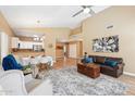 Open-concept living area with a fireplace, seamlessly connected to the kitchen and dining space at 4353 E Desert Wind Dr, Phoenix, AZ 85044