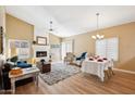 Bright living room featuring a cozy fireplace, high ceilings, and a blend of living and dining spaces at 4353 E Desert Wind Dr, Phoenix, AZ 85044