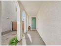 Inviting entryway featuring arched columns and a quaint, sage-green front door at 4803 S Ferric --, Mesa, AZ 85212