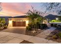 Charming single-story home with a well-maintained front yard and a spacious driveway leading to the garage at 4946 N 210Th Ave, Buckeye, AZ 85396