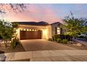 Beautiful single-story home featuring a well-kept front yard, desert landscaping and a brick-paved driveway at 4946 N 210Th Ave, Buckeye, AZ 85396