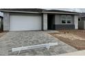 Charming single-story home with a spacious driveway and modern architectural design at 5634 W Olney Ave, Laveen, AZ 85339