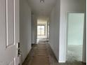 Bright hallway showcasing wood-look tile floors, leading to the living spaces and bedrooms at 5634 W Olney Ave, Laveen, AZ 85339
