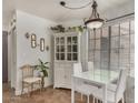 Bright dining area with modern lighting, white furniture, and decorative accents at 602 N May St # 65, Mesa, AZ 85201