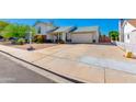 A view of the home's exterior, featuring a spacious driveway at 6031 E Inglewood St, Mesa, AZ 85205
