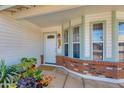 Inviting front porch area with decorative brickwork and potted plants at 6031 E Inglewood St, Mesa, AZ 85205