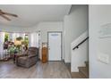 Bright living room with staircase and views of the front yard at 6031 E Inglewood St, Mesa, AZ 85205