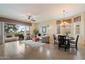 Open-concept living room featuring a ceiling fan and views of the landscaped backyard and golf course at 6202 E Mckellips Rd # 65, Mesa, AZ 85215