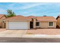 Inviting single-story home with a spacious driveway and easy-to-maintain landscaping at 6416 S 19Th Pl, Phoenix, AZ 85042