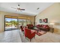 This living room is a cozy retreat with comfortable seating and lots of natural light from the large sliding glass door at 9717 W Marco Polo Rd, Peoria, AZ 85382