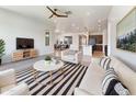 Bright and airy living room with stylish decor and a ceiling fan at 9845 E Tahoe Ave, Mesa, AZ 85212