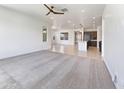 Spacious living area featuring an open layout and neutral carpet at 9845 E Tahoe Ave, Mesa, AZ 85212