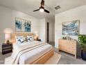Serene main bedroom with modern decor, fan, and natural light at 9845 E Tahoe Ave, Mesa, AZ 85212