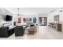 Spacious living room featuring modern decor, a fireplace and large windows at 10248 E San Salvador Dr, Scottsdale, AZ 85258