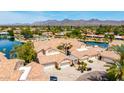 Wide aerial shot reveals a luxury home with a private driveway and terra cotta roof at 10390 E Lakeview Dr # 204, Scottsdale, AZ 85258