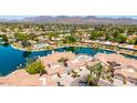 Expansive aerial view showcases the lakefront properties with terra cotta roofs at 10390 E Lakeview Dr # 204, Scottsdale, AZ 85258