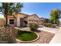 Inviting single-Gathering home with a lush front yard, decorative rock, and a concrete driveway at 11591 W Jefferson St, Avondale, AZ 85323