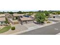 Expansive home features a 3 car garage, desert landscaping, and solar panels for energy efficiency at 1182 E Canyon Way, Chandler, AZ 85249