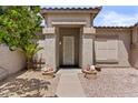 Inviting front entrance with decorative door, desert landscaping, and decorative planters at 1182 E Canyon Way, Chandler, AZ 85249