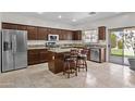 Spacious kitchen with granite countertops, stainless steel appliances, and a center island with seating at 1182 E Canyon Way, Chandler, AZ 85249
