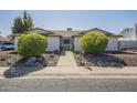 Inviting single-story home with a secure gated entrance and well-manicured landscaping at 12154 S Ki Rd, Phoenix, AZ 85044
