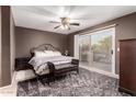 Comfortable bedroom with sliding glass doors and a ceiling fan at 14228 W Weldon Ave, Goodyear, AZ 85395