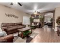 Spacious living room featuring hardwood floors, comfortable seating, and natural lighting at 14228 W Weldon Ave, Goodyear, AZ 85395