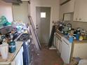 Dated kitchen with ample cabinet space requires updating and decluttering for a modern look at 14627 N 33Rd Ave, Phoenix, AZ 85053