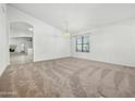 Bright and airy living room with carpet flooring and neutral paint scheme at 17210 N Cassi Dr, Surprise, AZ 85374