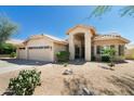 Charming single-story home featuring a three-car garage and low maintenance desert landscaping at 18907 N 92Nd Way, Scottsdale, AZ 85255