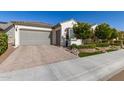 Charming single-story home featuring lush landscaping, beautiful stonework, three car garage and a neutral exterior at 19215 N 259Th Ave, Buckeye, AZ 85396