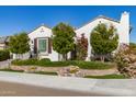 Charming single-story home featuring lush landscaping, beautiful stonework and a neutral-toned exterior at 19215 N 259Th Ave, Buckeye, AZ 85396