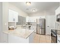 Bright kitchen featuring white cabinets, stainless steel appliances, and granite countertops at 1961 N Hartford St # 1087, Chandler, AZ 85225