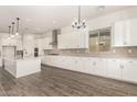 Spacious kitchen with white cabinetry, stainless steel appliances, and a view into the dining area at 20255 W Monterey Way, Buckeye, AZ 85396