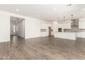 A large open living space with tile flooring, a kitchen with a center island, and plenty of natural light at 20255 W Monterey Way, Buckeye, AZ 85396