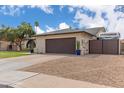 Spacious home with a well-maintained lawn, a two-car garage, and additional parking space at 2109 W El Alba Way, Chandler, AZ 85224
