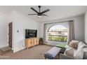 Bright living room featuring a large arched window, comfortable seating, and modern furnishings at 2109 W El Alba Way, Chandler, AZ 85224