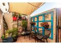 Cozy patio with potted plants, seating, and shade awning, perfect for outdoor relaxation at 2431 E Tracy Ln # 1, Phoenix, AZ 85032