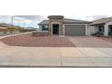 Charming single-Gathering home featuring low maintenance desert landscaping and an attached two car garage at 27053 W Ponderosa Ln, Buckeye, AZ 85396