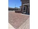 Charming single-story home with meticulously landscaped front yard, complemented by a stone facade and mountain views at 27053 W Ponderosa Ln, Buckeye, AZ 85396