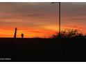 Fiery sunset scene showing the vivid orange and red sky overlooking the silhouette of the neighborhood at 27053 W Ponderosa Ln, Buckeye, AZ 85396